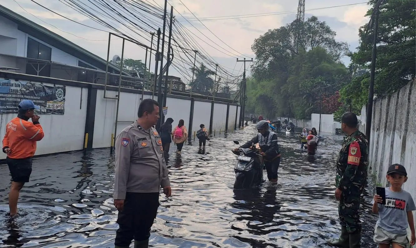 Bhabinkamtibmas dan Babinsa Pantau Banjir di Jalan Raya Cisirung, Arus Lalu Lintas Tetap Dijaga