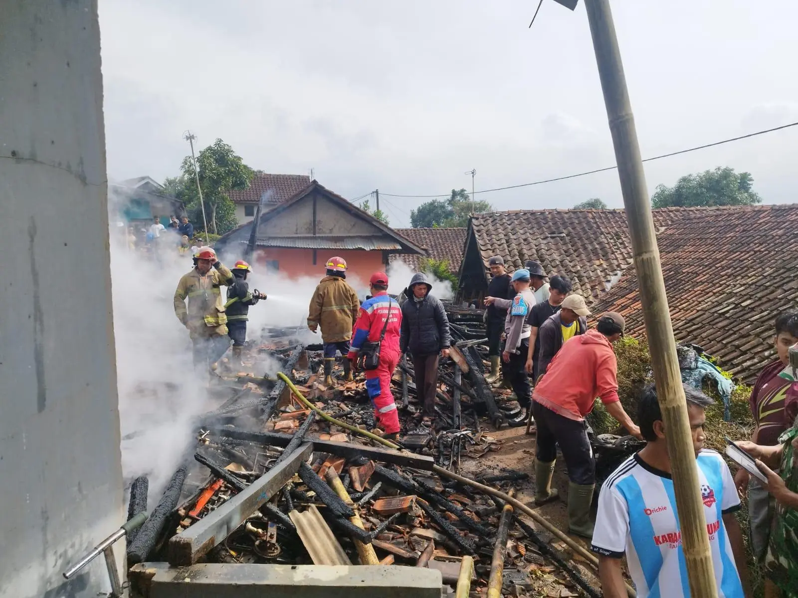 Polsek Pacet Bersama Damkar dan Warga Padamkan Kebakaran Tiga Rumah di Pacet